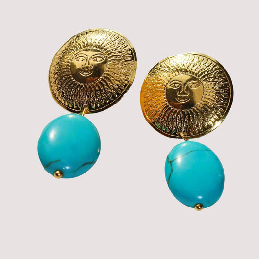 Beautiful handmade pieces with the face of the sun on top and a turquoise on
the bottom.